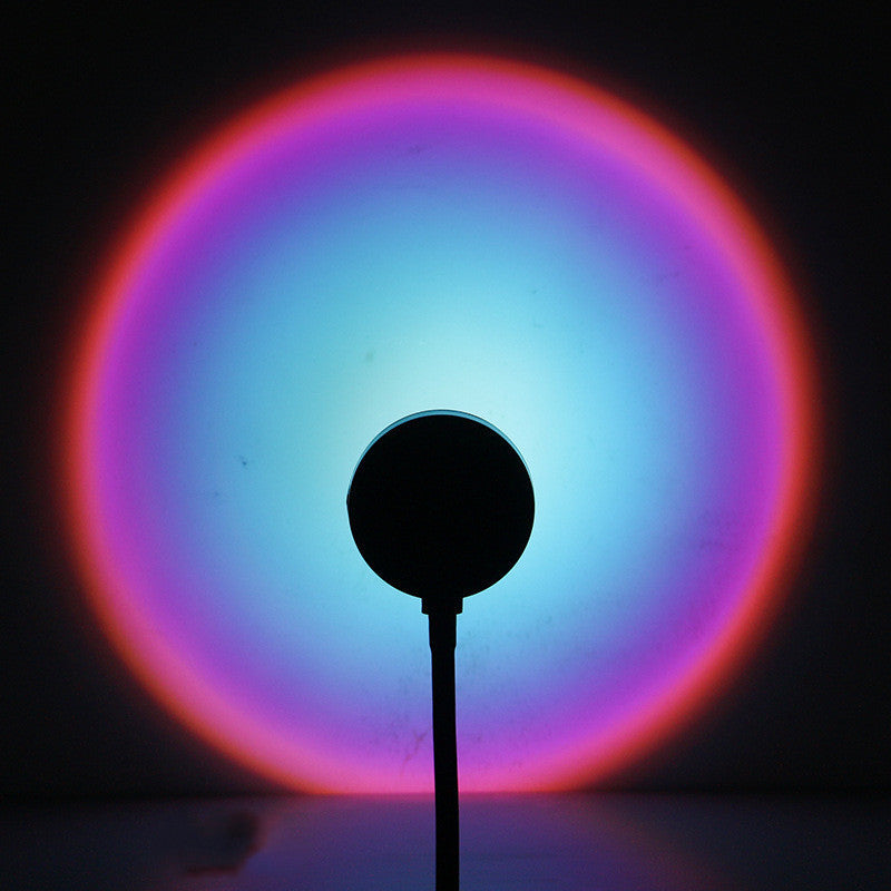 USB sunset projection lamp casting a warm golden-hour glow in a bedroom