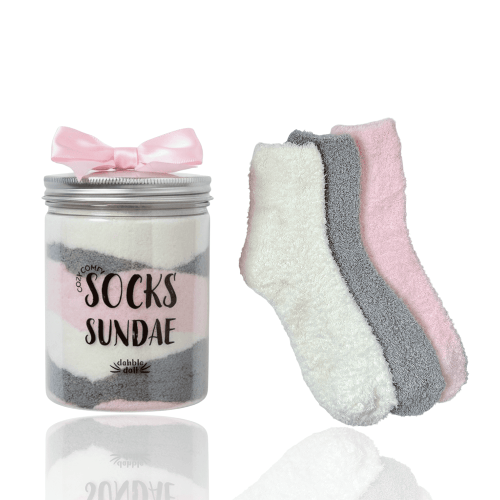 Three pairs of cozy socks in a sundae jar with a bow