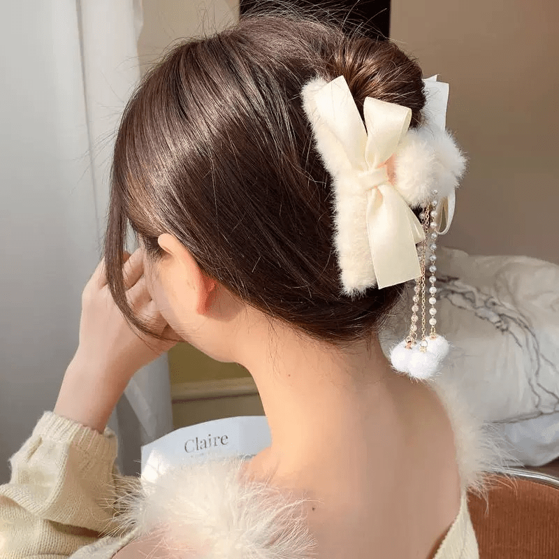 Two faux fur bow hair claw clips with pearl dangle tassels in cream and beige