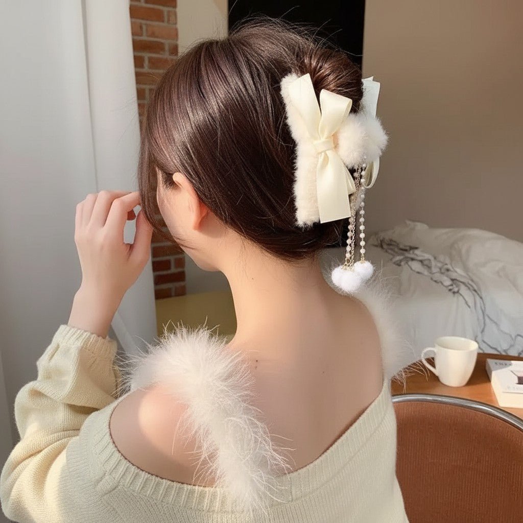 Two faux fur bow hair claw clips with pearl dangle tassels in cream and beige
