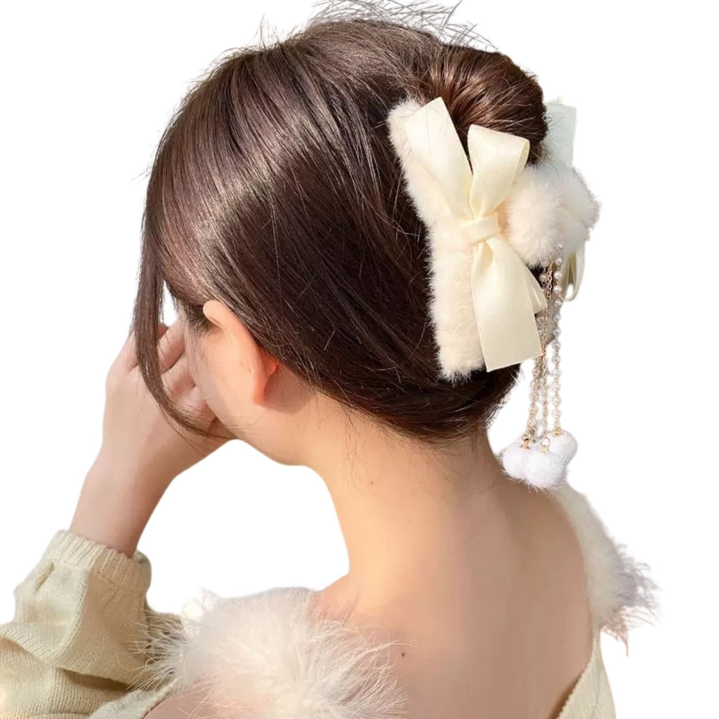Two faux fur bow hair claw clips with pearl dangle tassels in cream and beige