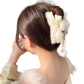 Two faux fur bow hair claw clips with pearl dangle tassels in cream and beige