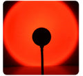 USB sunset projection lamp casting a warm golden-hour glow in a bedroom