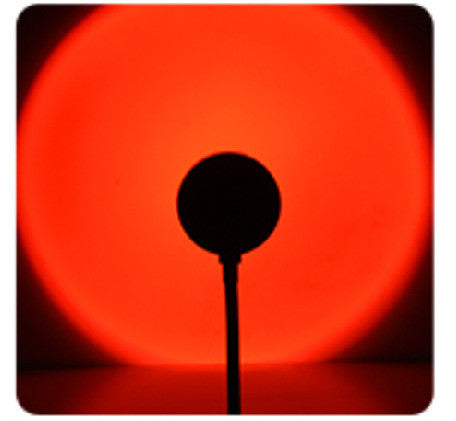 USB sunset projection lamp casting a warm golden-hour glow in a bedroom